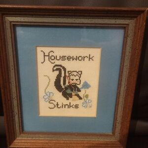 Framed Cross-Stitch Art with Skunk Design